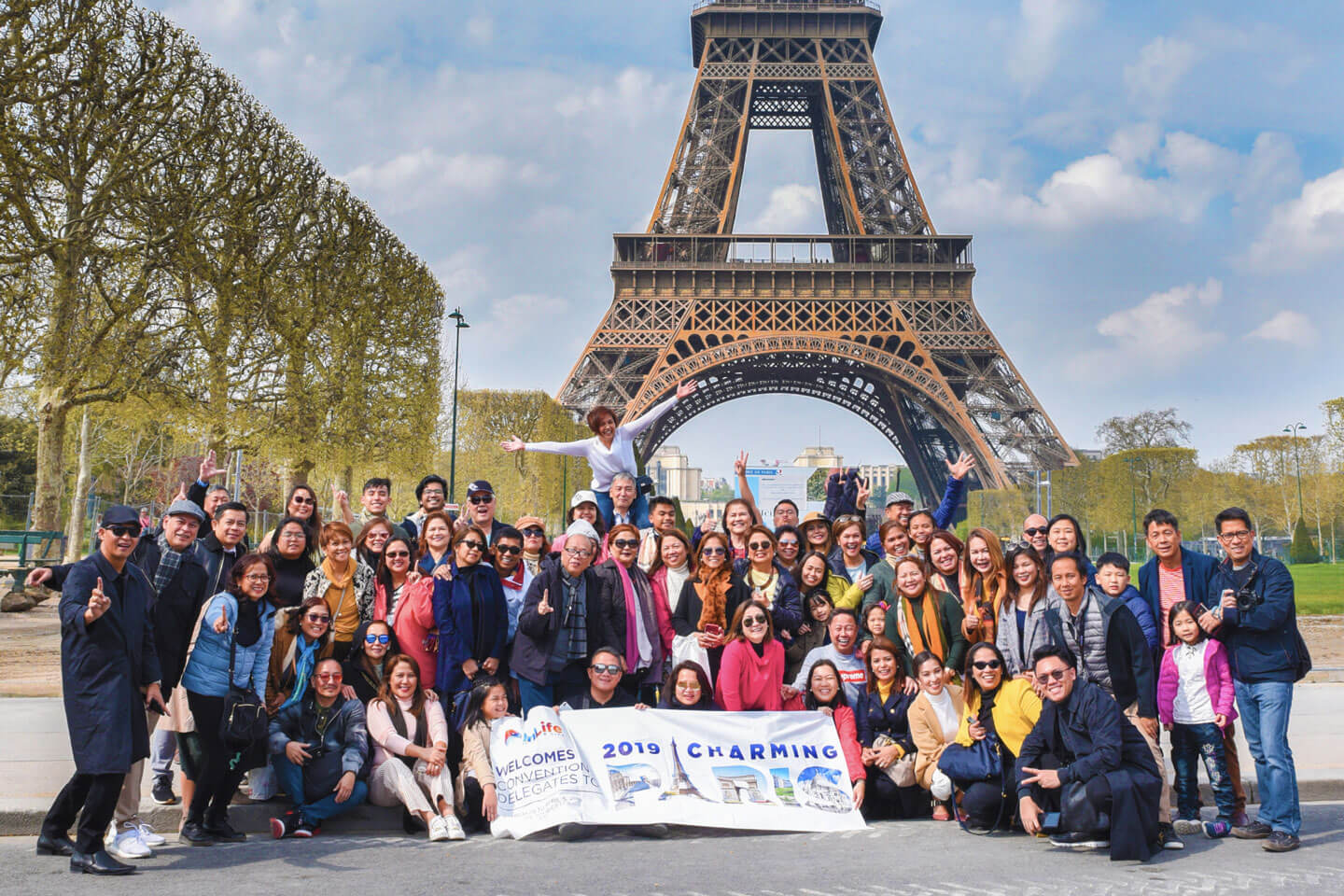 Insular Life employees behind Eiffel Tower